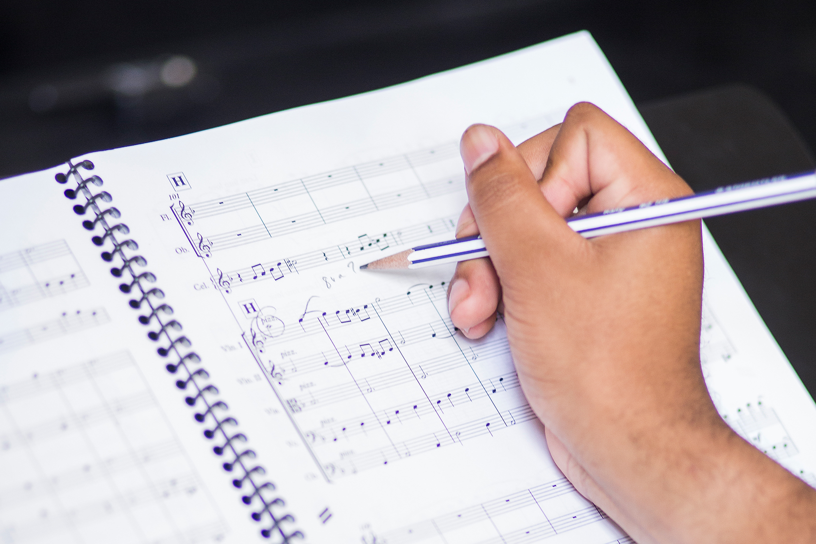 Student making notes on music score